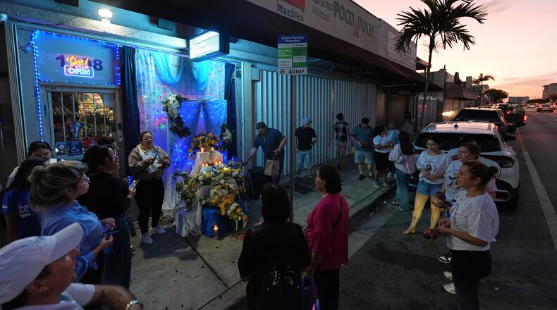 Nicaraguans sing in praise of the Virgin Mary at one of dozens of open-air altars set up near St. John Bosco Catholic Church in celebration of the Dec. 8 feast of the Immaculate Conception, Sunday, Dec. 7, 2025, in Miami. (AP Photo/Rebecca Blackwell)