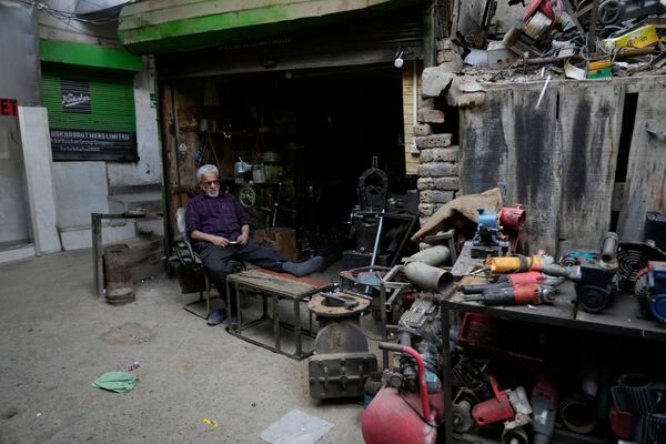 Bashir Ahmad, a Kashmiri shopkeeper, rests at his shop inside the Auqaf Market in Srinagar, Indian controlled Kashmir, Wednesday, April 2, 2025. (AP Photo/Mukhtar Khan)