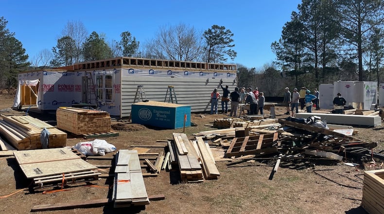 Volunteers from First Baptist Duluth, Christ the King Lutheran and future Habitat for Humanity homeowners work to build one of four houses in Lawrenceville. PHOTO BY KAREN HUPPERTZ FOR THE AJC