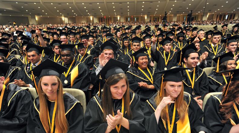 WOODSTOCK HS GRADUATION--May 23, 2013 Woodstock - Sequoyah High School graduates cheer during their Graduation Ceremony at First Baptist Church of Woodstock on Thursday, May 23, 2013. For the first time, high school graduations in DeKalb can no longer be held in churches this year. In the past, some school systems have used churches -- and Cherokee still does -- for cost and size reasons. HYOSUB SHIN / HSHIN@AJC.COM