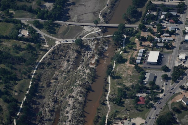Water flows through the Guadalupe River on Tuesday, July 8, 2025, after a flash flood swept through the area in Kerrville, Texas. (AP Photo/Ashley Landis)