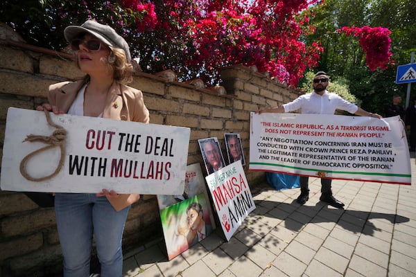 Iranian citizens protest against the current Iranian government outside the Omani Embassy in Rome during the closed-door meeting between U.S. and Iranian delegations to discuss Tehran's rapidly advancing nuclear program, Friday, May 23, 2025. (AP Photo/Andrew Medichini)