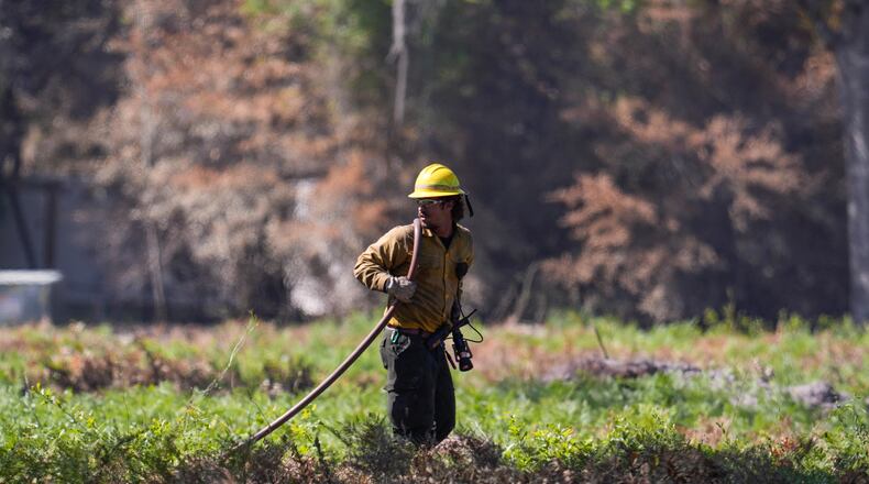 A firefighter works the Brantley Highway 82 fire, Thursday, April 23, 2026, near Nahunta, Ga. (AP Photo/Mike Stewart)