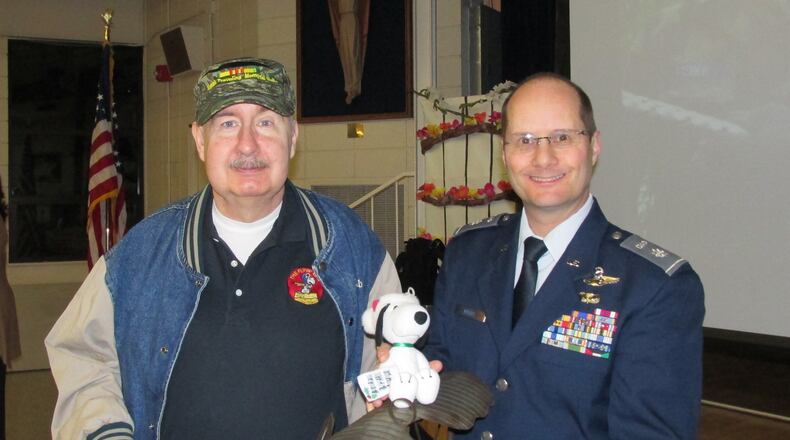 Vietnam War veteran Joe Congleton (left) and Lt. Col Brian Berry show off the model of a World War I plane piloted by the cartoon character Snoopy. The Sandy Springs Cadet Squadron of the Civil Air Patrol presented it to Congleton, who designed the squadron s Snoopy-themed patch in 1967.