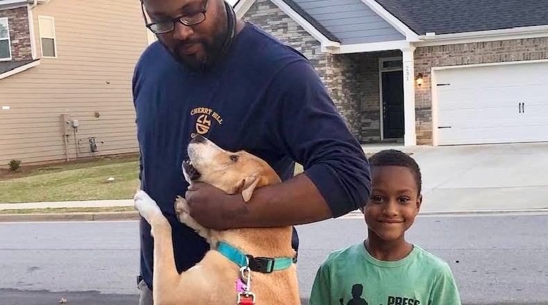 Recent clients of Paws Between Homes are reunited with their dog Ruby. The nonprofit provides free shelter for pets of families experiencing a housing crisis. Courtesy of Paws Between Homes