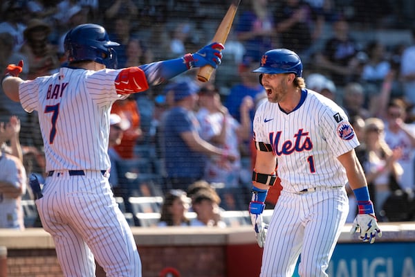 New York Mets' Jeff McNeil (1) celebrates with Brett Baty (7) after scoring on his two-run home run during the seventh inning of a baseball game against the New York Yankees, Friday, July 4, 2025, in New York. (AP Photo/Angelina Katsanis)