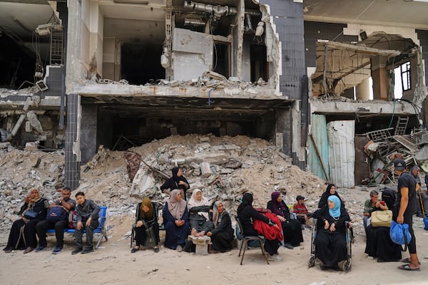 Kidney patients sit amid the destruction caused by the Israeli army at Shifa Hospital compound in Gaza City on Tuesday, July 1, 2025, as they wait to leave after the facility suspended its dialysis unit services due to fuel shortages needed to power its generators. (AP Photo/Jehad Alshrafi)