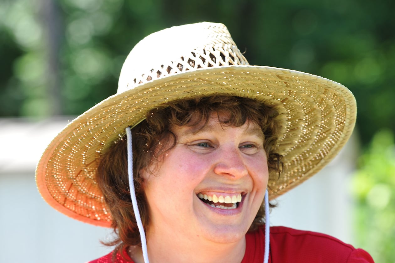 Mandi Albright, an online audience specialist for The Atlanta Journal-Constitution, lost her father in 2005 and mother in late 2011. Working in the garden at the home they shared in Morrow is helping her cope with the grief. HYOSUB SHIN / HSHIN@AJC.COM