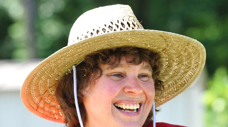 Mandi Albright, an online audience specialist for The Atlanta Journal-Constitution, lost her father in 2005 and mother in late 2011. Working in the garden at the home they shared in Morrow is helping her cope with the grief. HYOSUB SHIN / HSHIN@AJC.COM