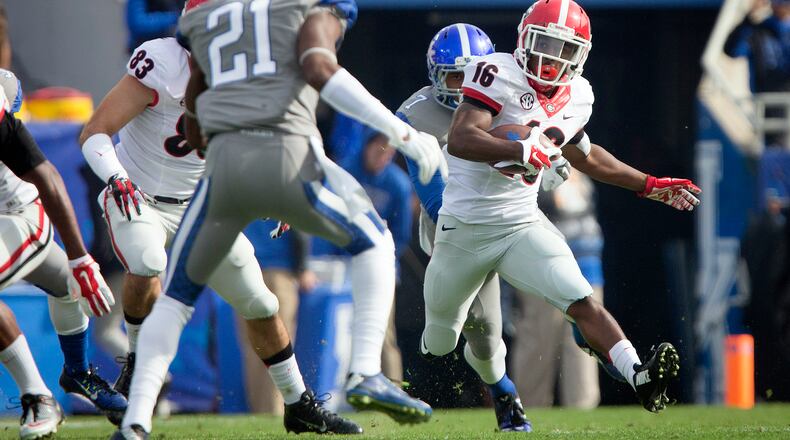 Georgia wide receiver Isaiah McKenzie, right, returns a kickoff for a touchdown during the first half of an NCAA college football game against Kentucky at Commonwealth Stadium in Lexington, Ky., Saturday, Nov. 8, 2014. (AP Photo/David Stephenson)