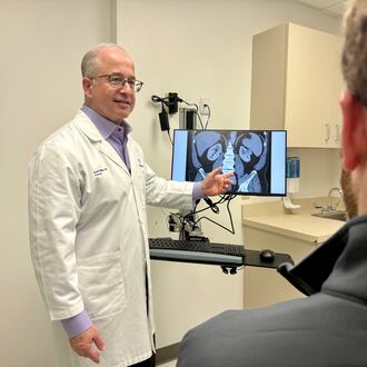 Dr. Scott Miller, a longtime urologist with Wellstar Health System, talks with a patient about men's health. (Courtesy of Wellstar Health System)