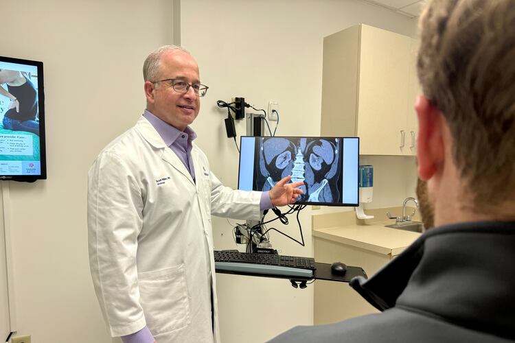 Dr. Scott Miller, a longtime urologist with Wellstar Health System, talks with a patient about men's health. (Courtesy of Wellstar Health System)