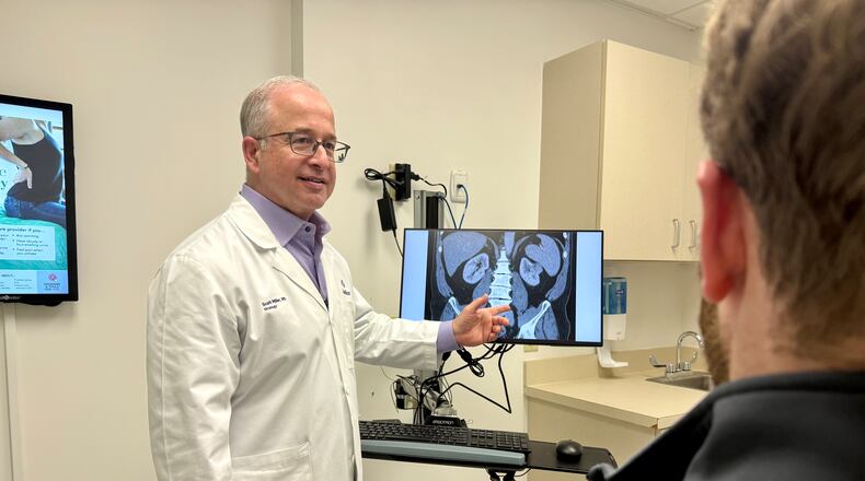 Dr. Scott Miller, a longtime urologist with Wellstar Health System, talks with a patient about men's health. (Courtesy of Wellstar Health System)