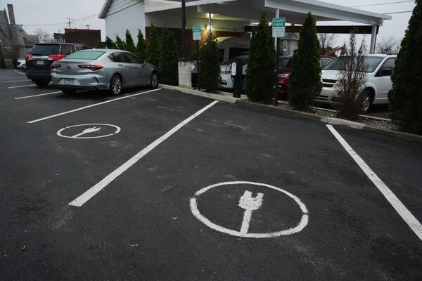 Electric vehicle parking spots sit near charging stations, Friday, April 11, 2025, in Evansville, Ind. (AP Photo/Joshua A. Bickel)