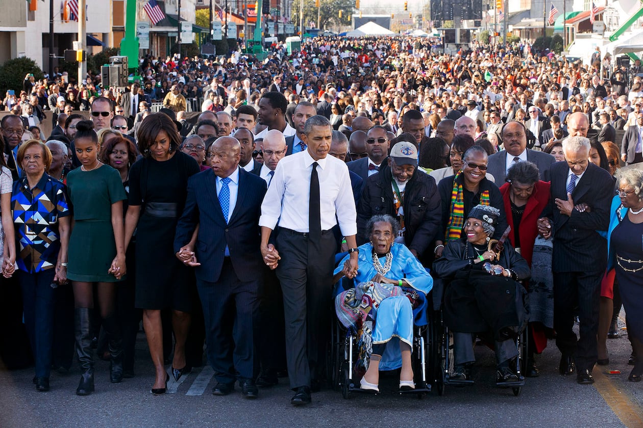 John Lewis returned every year to Selma to walk across the Edmund Pettus Bridge. In 2015, he commemorated the 50th anniversary of Bloody Sunday by joining hands with President Barack Obama and his family and leading a march. Other survivors of Bloody Sunday helped lead the procession. The event included a rare joint appearance by Obama and President George W. Bush, who also attended. (Jacquelyn Martin/AP)