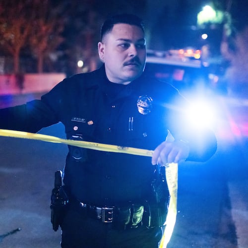 A police officer blocks off a street near Rob Reiner's residence Sunday, Dec. 14, 2025, in the Brentwood section of Los Angeles. (AP Photo/Ethan Swope)