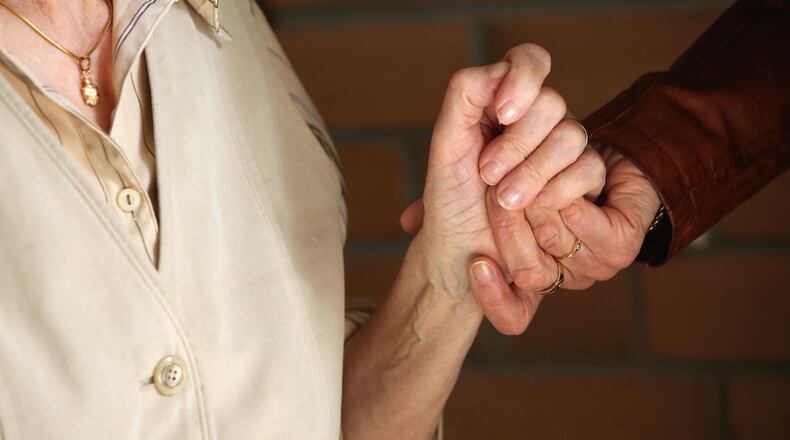 BESTENSEE, GERMANY - MARCH 14:  Elderly residents hold hands during the ten-year anniversary celebration of the Bestensee Senior Care Center (Seniorenzentrum Bestensee) on March 14, 2014 in Bestensee near Berlin, Germany. The assisted living center, which provides home, food, conversation and cultural diversion to elderly citizens, is run by the Berliner Stadtmission, a charity association led by the region's Evangelical church.  (Photo by Adam Berry/Getty Images)