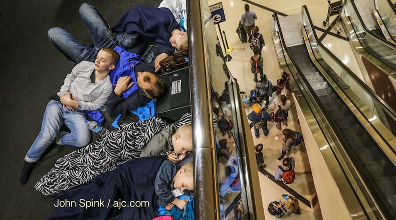 The Ravnevand family of Norway had to sleep in the Atlanta airport because of Wednesday’s storms. JOHN SPINK / JSPINK@AJC.COM
