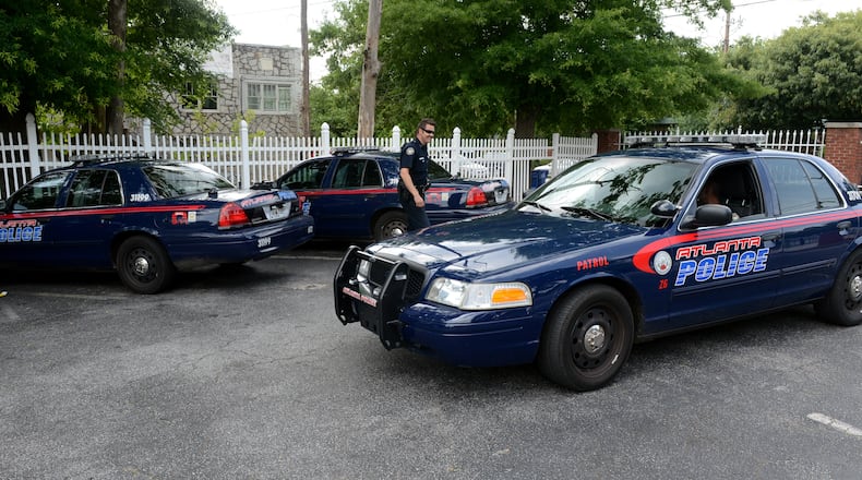 Atlanta Police officers in the Zone 6, East Precinct, inspect and swap out patrol cars before deploying in the area Tuesday, June 4, 2013. KENT D. JOHNSON/KDJOHNSON@AJC.COM