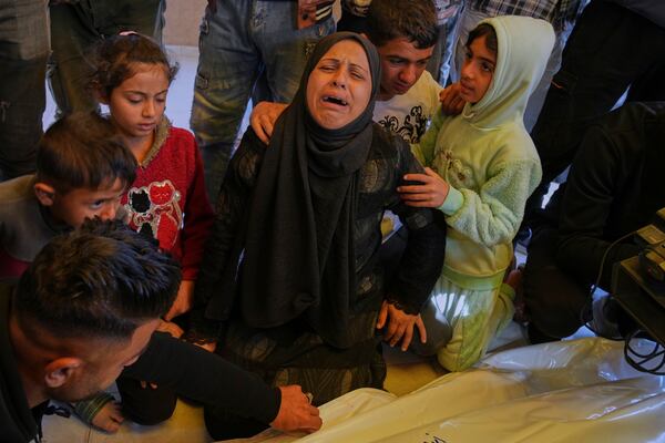 Inas Al Aqqad mourns the body of her husband Ashraf, who was killed in an Israeli army strike, before his burial at the hospital in Khan Younis, southern Gaza Strip, Thursday, April 3, 2025. (AP Photo/Abdel Kareem Hana)