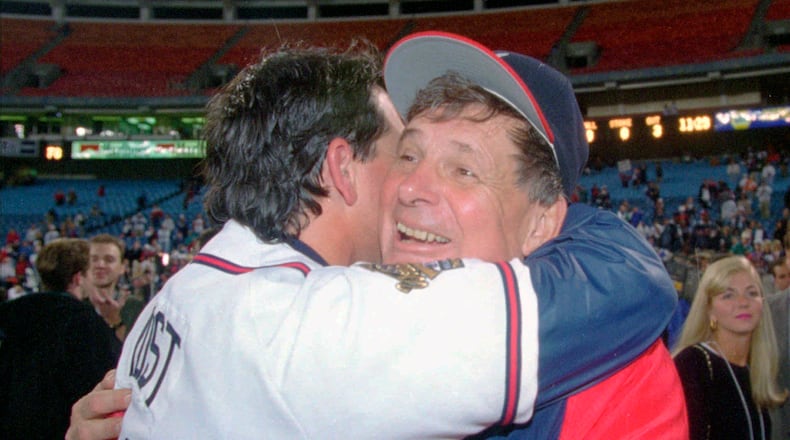 Manger Bobby Cox, right, hugs bullpen coach Ned Yost after the Braves locked up the World Series against Cleveland 25 years ago. (AP Photo/John Bazemore, File)