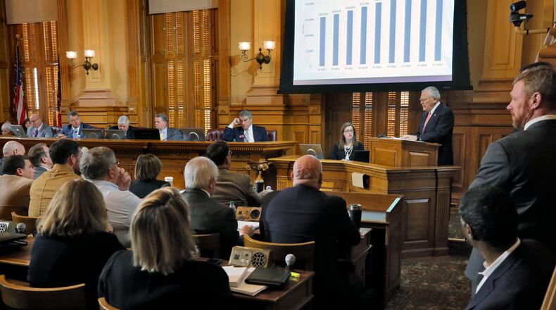 Chris Riley (far right), Gov. Nathan Deal’s chief of staff, watches as Deal outlines his budget before the joint appropriation committee this morning at the Capitol. BOB ANDRES /BANDRES@AJC.COM
