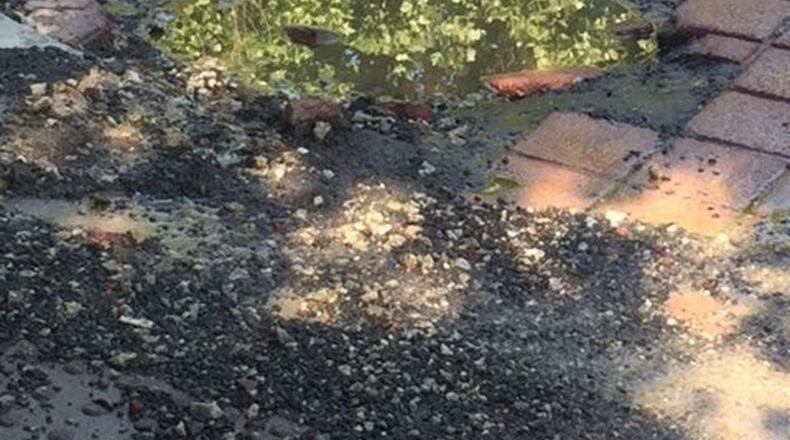 Stephanie Roberts hopes this hole can be fixed that is in the heart of Midtown. Photo/Stephanie Roberts.