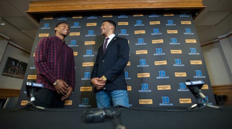 Former Duke University football player Blair Holliday, right, shares a laugh with his brother, Chase, following a press conference at Cameron Indoor Stadium in Durham, N.C., Thursday, Holliday will walk across the stage this weekend during Duke's graduation ceremonies. (Kaitlin McKeown/The Herald-Sun via AP) MANDATORY CREDIT