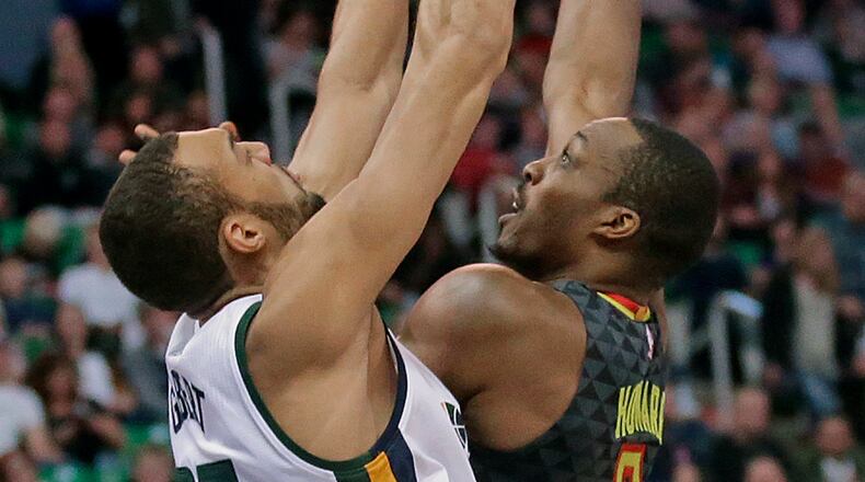 Atlanta Hawks center Dwight Howard (8) shoots as Utah Jazz center Rudy Gobert, left, defends in the first half during an NBA basketball game Friday, Nov. 25, 2016, in Salt Lake City. (AP Photo/Rick Bowmer)