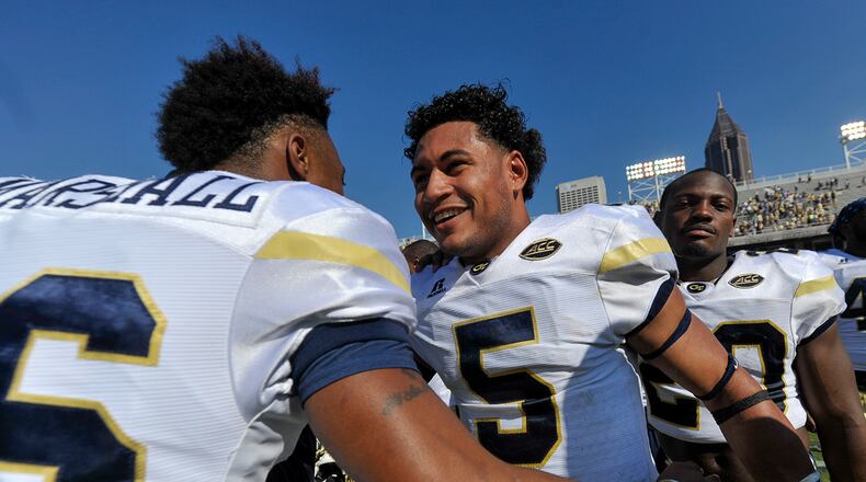 Georgia Tech senior quarterback Justin Thomas (5) celebrates with sophomore QB TaQuon Marshall (16) after the Yellow Jackets’ 38-35 win over Duke last week. (SPECIAL/Daniel Varnado)