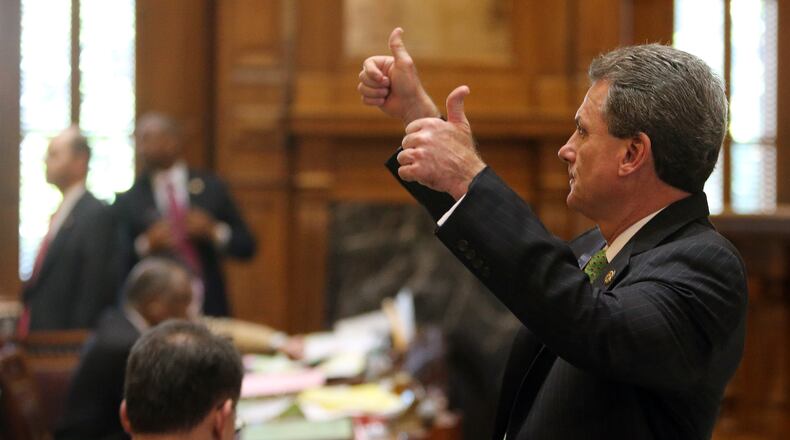 Then-state Sen. Buddy Carter signals which way his fellow Republicans should vote on a bill to require drug testing of some food stamp recipients during the last day of the legislative session on March 20, 2014. BEN GRAY / BGRAY@AJC.COM