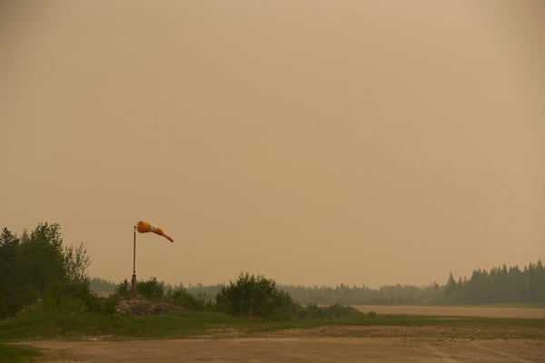 Smoke filled skies from out of control wildfires in Norway House, Manitoba Tuesday, June 3, 2025, at the Norway House Airport as crews continue to fight wildfires in northern Manitoba. (David Lipnowski/The Canadian Press via AP)