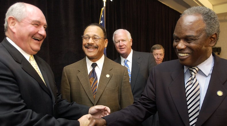 Then-Gov. Sonny Perdue , left, shakes hands with U.S. Rep. David Scott following a press conference to discuss their testimony before the Base Realignment and Closure Commission in 2005. (BEN GRAY/AJC).