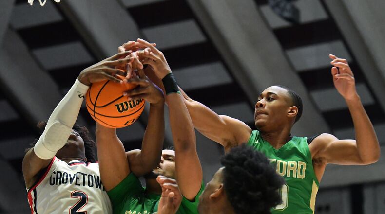 March 11, 2022 Macon - Grovetown's Frankquon Sherman (2) fights for a rebound with Buford's London Williams (23) and Buford's David Burnett (right) during the 2022 GHSA State Basketball Class AAAAAA Boys Championship game at the Macon Centreplex in Macon on Friday, March 11, 2022. (Hyosub Shin / Hyosub.Shin@ajc.com)