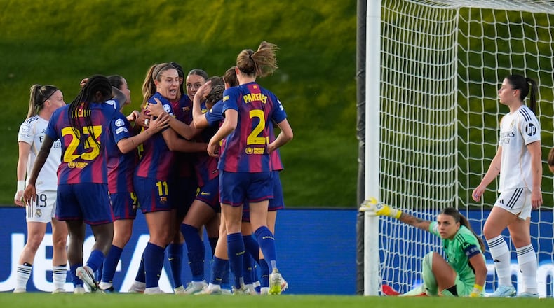 Barcelona players celebrate after Esmee Brugts scored her side's second goal during the women's Champions League quarterfinal first leg soccer match between Real Madrid and Barcelona in Madrid, Spain, Wednesday, March 25, 2026. (AP Photo/Manu Fernandez)