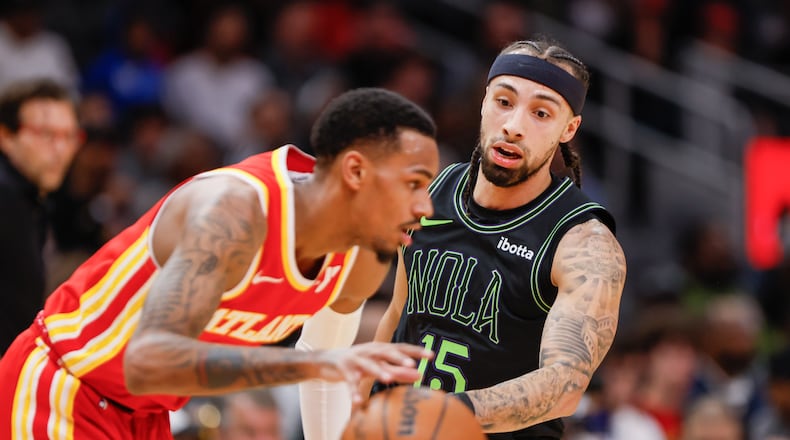 Pelicans guard Jose Alvarado applies defense to Hawks guard Dejounte Murray during the March 10 matchup at State Farm Arena.