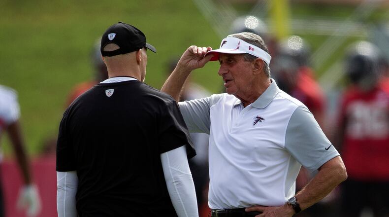 Falcons owner Arthur Blank talks with coach Dan Quinn during training camp.