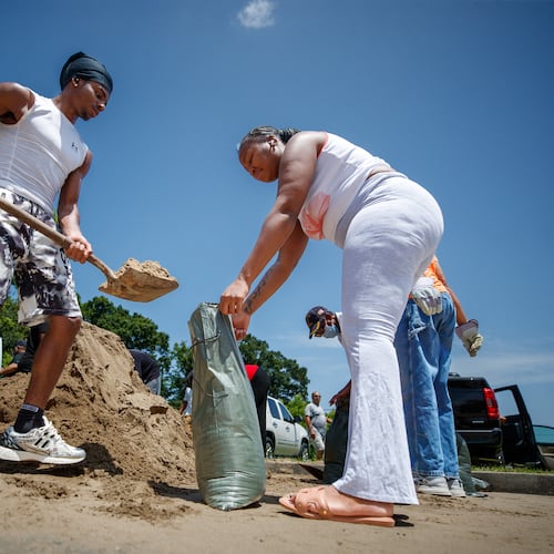 Christian Mosley-Richardson, left, helps Johnisha West fill sandbags ahead of Tropical Storm Bertha at Morris FX Jeff Sr. Park in Algiers, New Orleans, Monday, July 20, 2026. (David Grunfeld/The Times-Picayune/The New Orleans Advocate via AP)