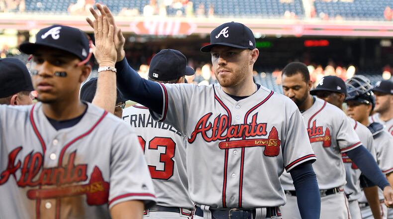 Braves' Freddie Freeman celebrates a win with teammates after a baseball game against the Washington Nationals at Nationals Park on July 8, 2017, in Washington, DC.