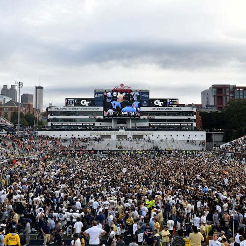 Georgia Tech fans storm the field after an NCAA college football game against Miami at Georgia Tech's Bobby Dodd Stadium, 2024, in Atlanta. (Hyosub Shin/AJC)