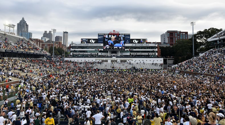 Georgia Tech fans storm the field after an NCAA college football game against Miami at Georgia Tech's Bobby Dodd Stadium, Saturday, November 9, 2024, in Atlanta. Georgia Tech won 28-23 over Miami. (Hyosub Shin / AJC)