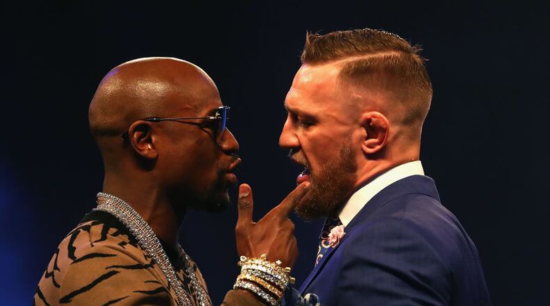 Floyd Mayweather (left) and Conor McGregor continue to hype their upcoming fight.