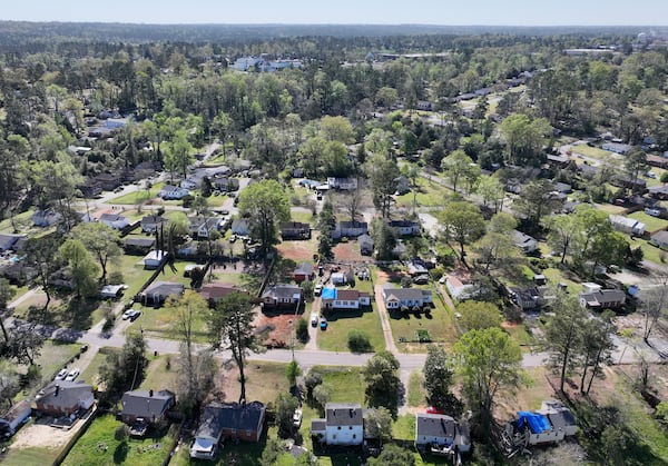 Aerial photo shows neighborhoods near Augusta National Golf Club (background), six months after Hurricane Helene landed. Some of the storm’s worst impacts were in Augusta, far from where it came on shore. (Hyosub Shin/AJC)