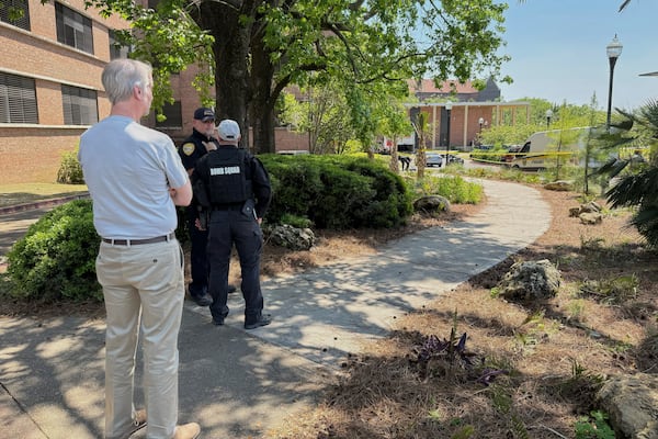 Dozens of patrol vehicles, including a forensics van, are stationed outside of Florida State University’s student union building, the scene of a shooting, Thursday, April 17, 2025, in Tallahassee, Fla. (AP Photo/Kate Payne)