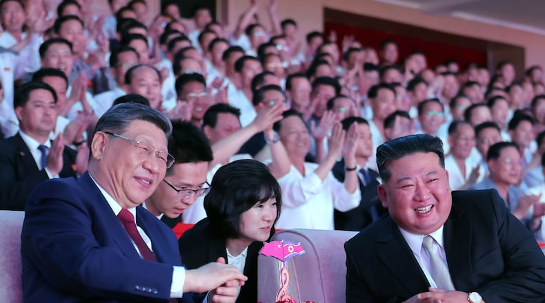 In this photo provided by the North Korean government, North Korean leader Kim Jong Un, right, and Chinese President Xi Jinping, left, smile as they watch welcome performance at Pyongyang Gymnasium in Pyongyang, Monday, June 8, 2026. Independent journalists were not given access to cover the event depicted in this image distributed by the North Korean government. The content of this image is as provided and cannot be independently verified. Korean language watermark on image as provided by source reads: "KCNA" which is the abbreviation for Korean Central News Agency. (Korean Central News Agency/Korea News Service via AP)