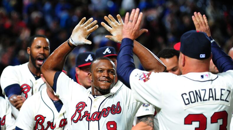 ATLANTA, GA - APRIL 6: Justin Upton #8 of the Atlanta Braves is congratulated by Manager Fredi Gonzalez #33 after his ninth inning game-winning home run against the Chicago Cubs at Turner Field on April 6, 2013 in Atlanta, Georgia. (Photo by Scott Cunningham/Getty Images) Justin Upton has been the Braves' best home-run hitter the past two seasons, but with only one season left on his contract he could be traded this winter.