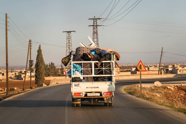 FILE - Syrian refugee Ahmed al-Kassem and his family drive a truck loaded with their belongings from Turkey, on the their way back to the family's home in Aleppo, Syria, Friday, Dec. 13, 2024. (AP Photo/Khalil Hamra, File)