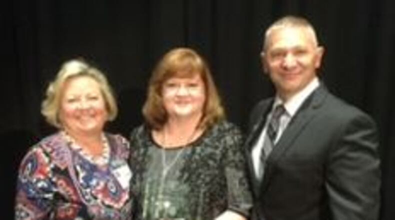 From left, Gwinnett County Public Schoos social studies director Debbie Daniell, Duluth High School teacher Geri Flanary, and Duluth High School principal Anthony Smith