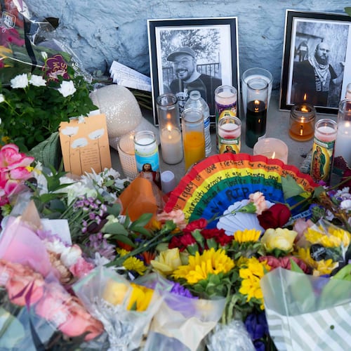 A growing memorial sits outside the Venture-N bar in Tucson, Ariz., Tuesday, Sept. 1, 2026, for Vincent Anthony Siquieros and Cameron Davis Capara, who were fatally shot in the parking lot of the gay bar shortly after midnight on Monday. (AP Photo/Rebecca Noble)
