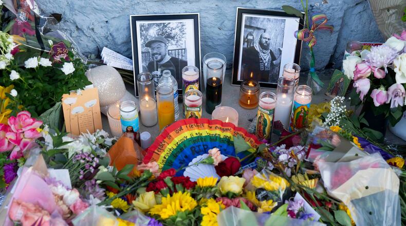 A growing memorial sits outside the Venture-N bar in Tucson, Ariz., Tuesday, Sept. 1, 2026, for Vincent Anthony Siquieros and Cameron Davis Capara, who were fatally shot in the parking lot of the gay bar shortly after midnight on Monday. (AP Photo/Rebecca Noble)